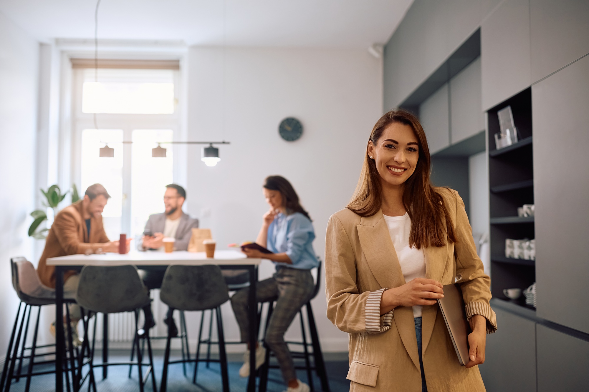 Young happy businesswoman at casual office looking at camera.