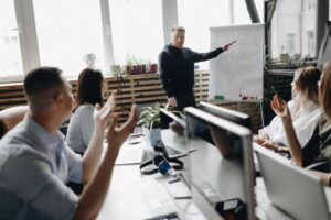 Staff meeting of a young successful team in the light modern office equipped with modern office