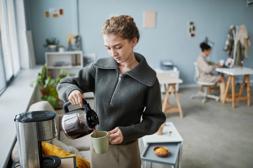 Woman drinking coffee at office