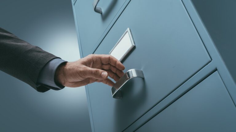Office clerk searching files in the filing cabinet