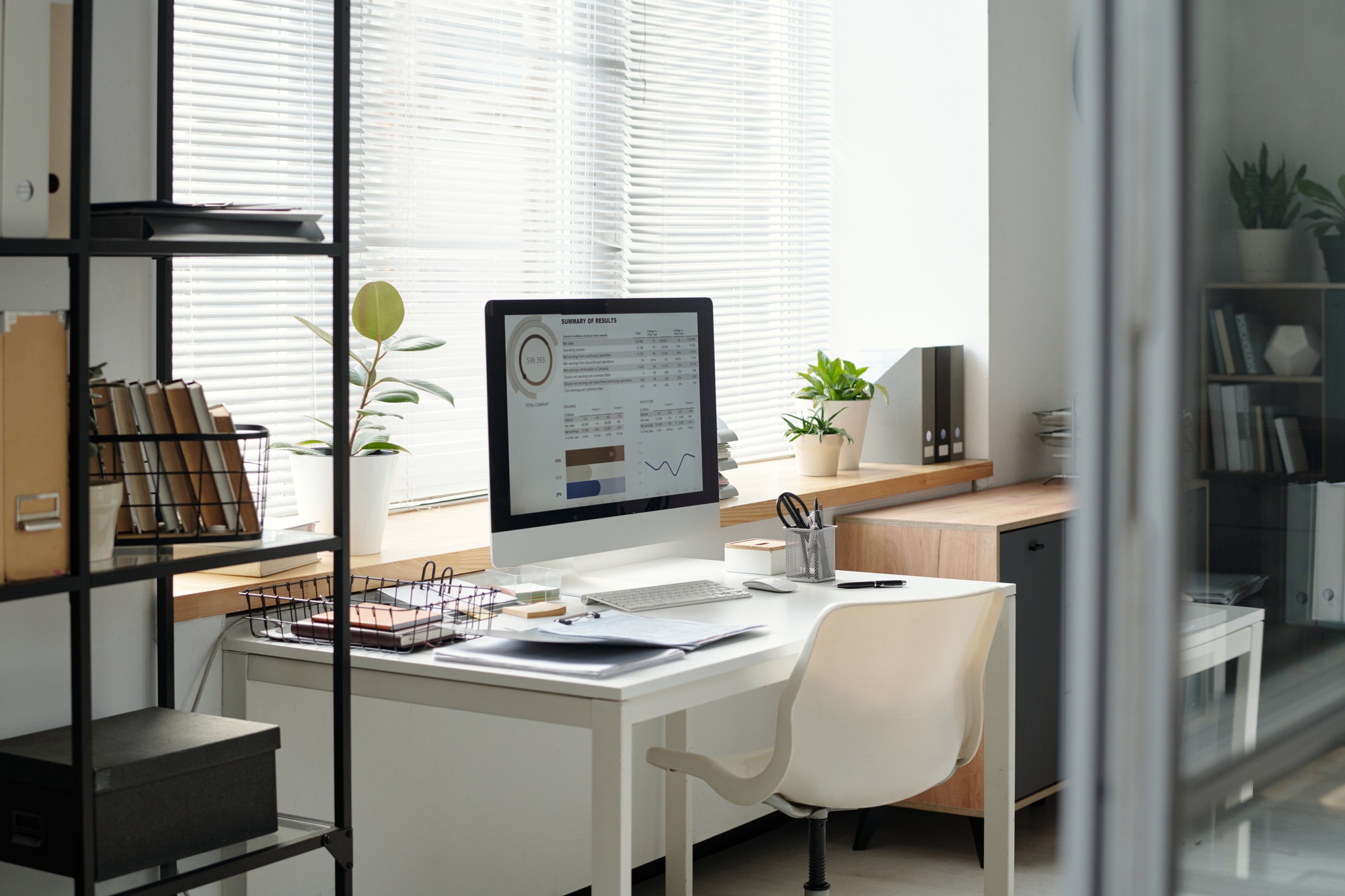 Small Office Workplace with Statistics Graphics on PC Screen